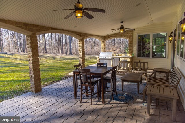 view of patio / terrace featuring outdoor dining area, ceiling fan, and grilling area