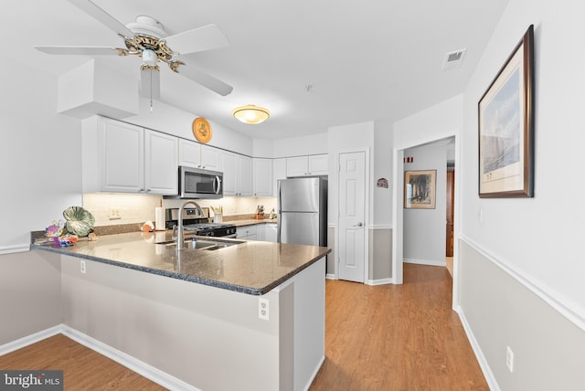 508 Limerick Cir Unit 304, Lutherville Timonium, MD 21093 - kitchen featuring appliances with stainless steel finishes, a peninsula, white cabinets, a ceiling fan, and light wood-style flooring