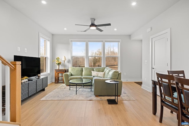 living area featuring visible vents, baseboards, a ceiling fan, light wood-type flooring, and recessed lighting