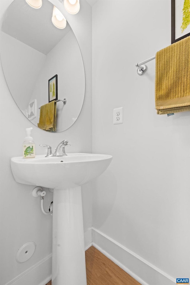 bathroom with baseboards and wood finished floors