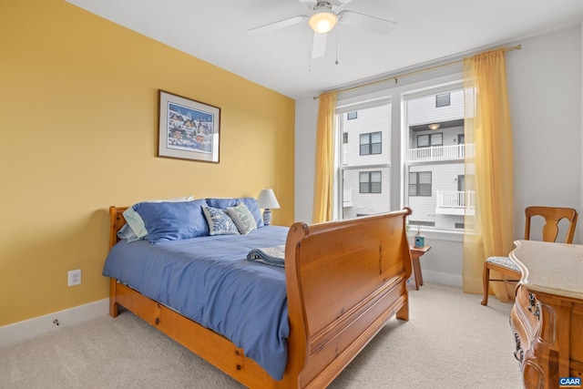 bedroom featuring light carpet, ceiling fan, and baseboards