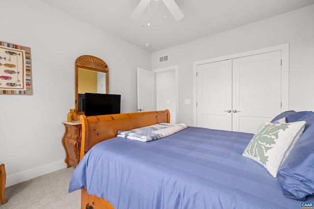 bedroom with baseboards, visible vents, ceiling fan, carpet floors, and a closet