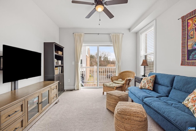 living room featuring a wealth of natural light, light colored carpet, and ceiling fan