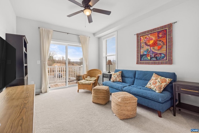 living room with carpet and a ceiling fan