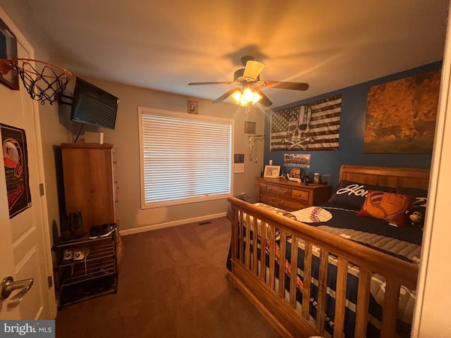 carpeted bedroom with ceiling fan and baseboards