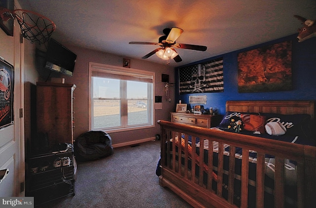 carpeted bedroom featuring a ceiling fan and baseboards