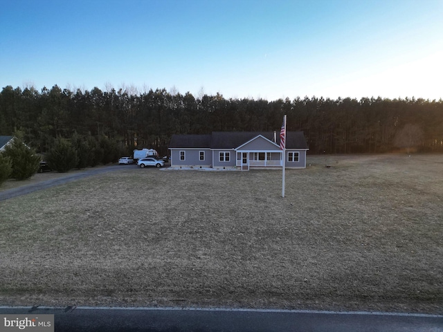 view of front of house with a wooded view