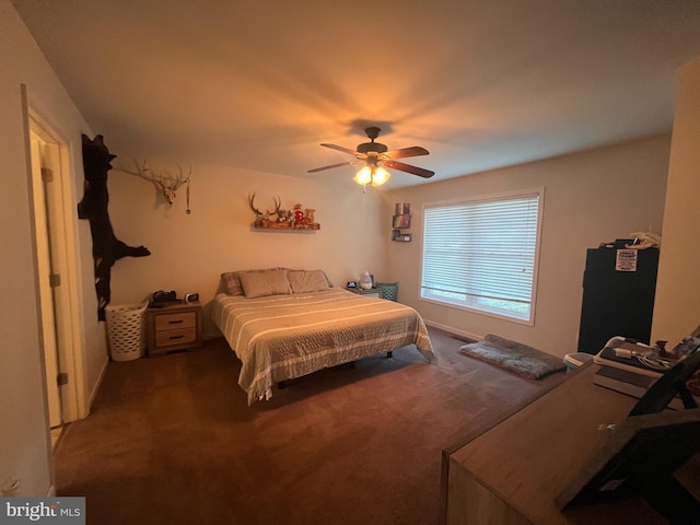 bedroom featuring carpet, ceiling fan, and refrigerator