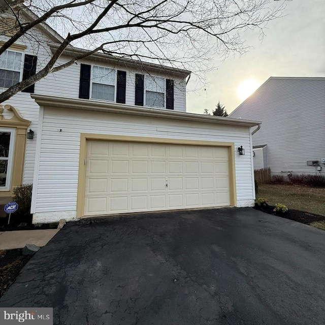 garage with aphalt driveway