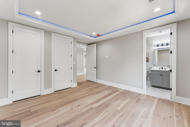 6935 Southridge Dr, Mclean, VA 22101 - unfurnished bedroom with a tray ceiling, light wood finished floors, recessed lighting, and connected bathroom