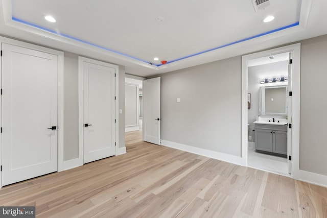 6935 Southridge Dr, Mclean, VA 22101 - unfurnished bedroom with light wood-style floors, a raised ceiling, recessed lighting, connected bathroom, and baseboards