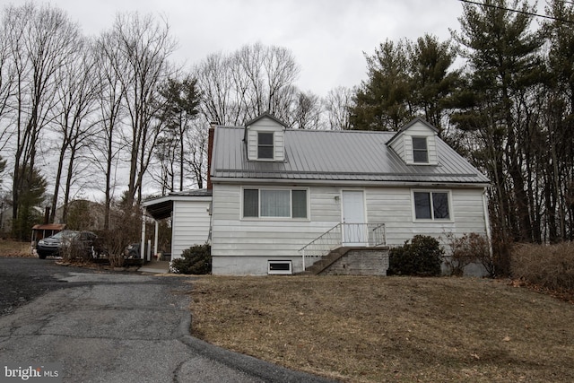 cape cod home with metal roof