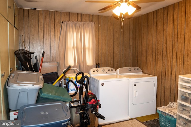 laundry area featuring wooden walls, independent washer and dryer, laundry area, and a ceiling fan