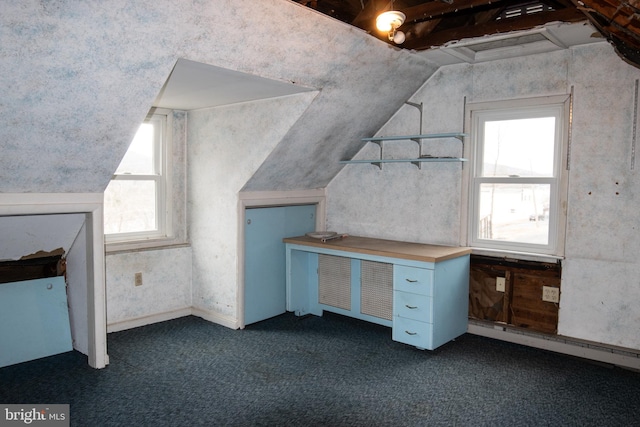 unfurnished office with lofted ceiling and dark carpet