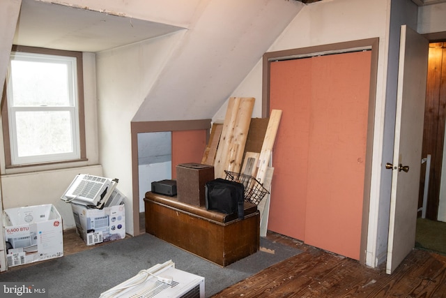 home office with wood finished floors and vaulted ceiling