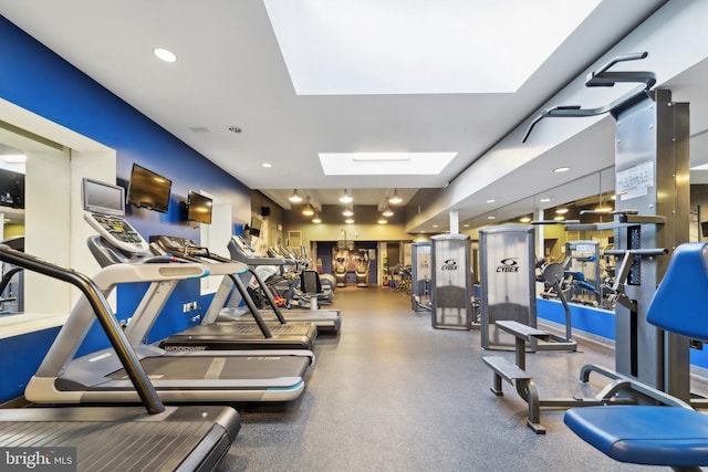 workout area featuring a skylight and recessed lighting