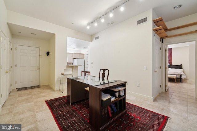 dining space with track lighting, visible vents, and baseboards