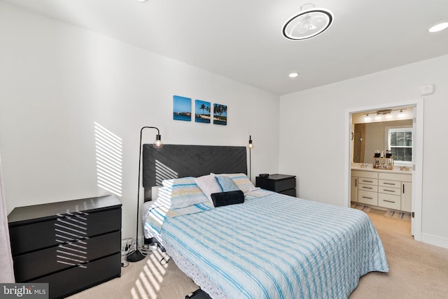 bedroom with recessed lighting, light carpet, connected bathroom, and baseboards