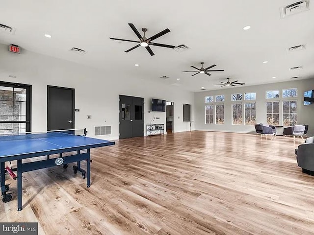 recreation room with light wood-style floors, ceiling fan, and visible vents