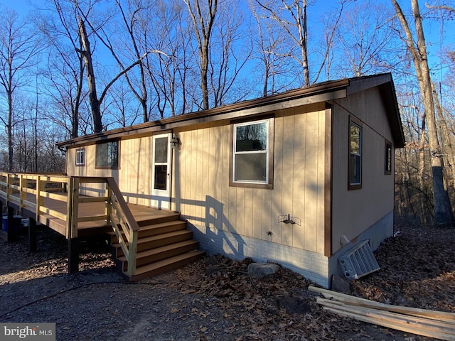 view of front of house with crawl space and a wooden deck