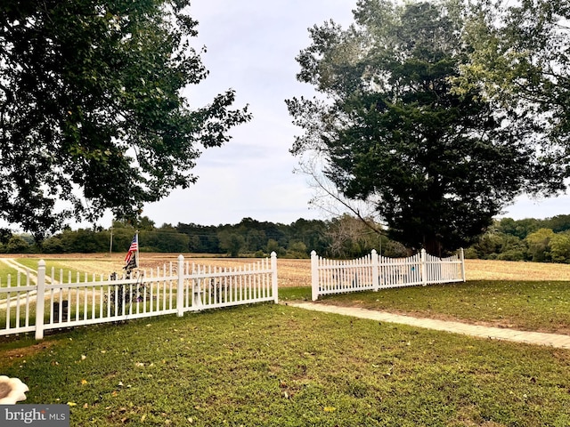 view of yard with a rural view and fence