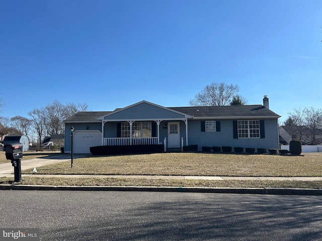 single story home with driveway, a garage, a chimney, covered porch, and a front lawn