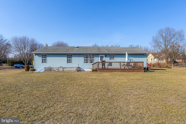 rear view of property with a yard and a wooden deck