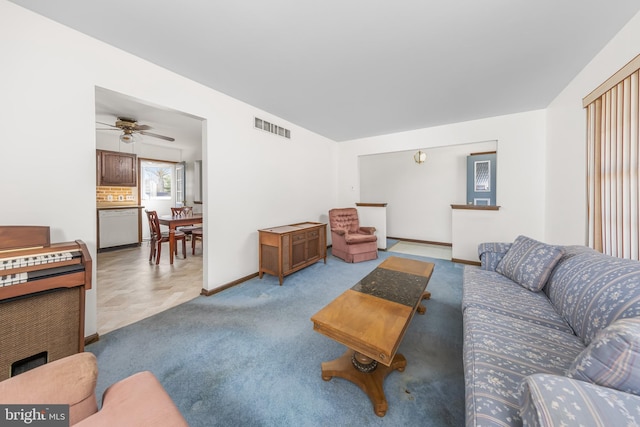 carpeted living area featuring baseboards, visible vents, and ceiling fan