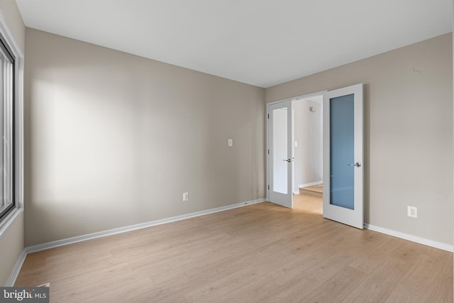 unfurnished bedroom with light wood-type flooring and baseboards