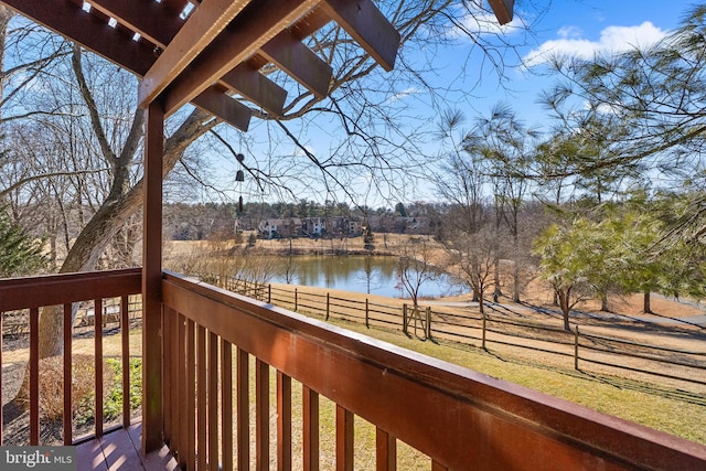 deck featuring a water view and fence