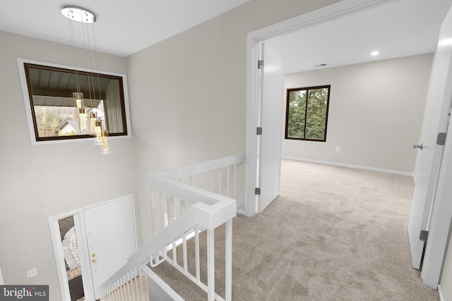 corridor with recessed lighting, carpet, baseboards, and an upstairs landing