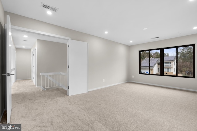 spare room with recessed lighting, baseboards, visible vents, and carpet flooring