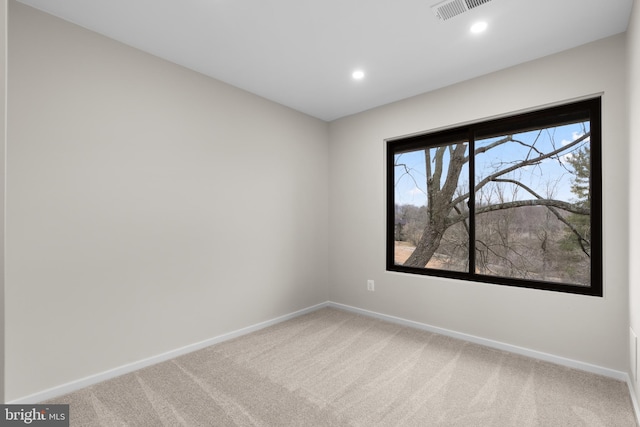 spare room with carpet floors, visible vents, baseboards, and recessed lighting