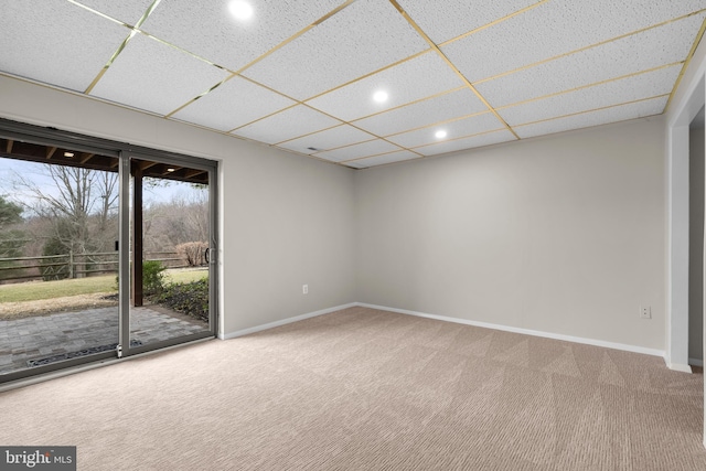 empty room featuring carpet, a paneled ceiling, baseboards, and recessed lighting