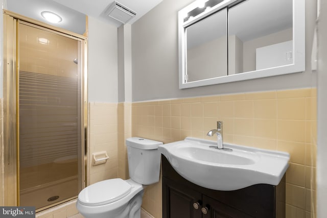 bathroom featuring visible vents, toilet, tile walls, and a shower stall