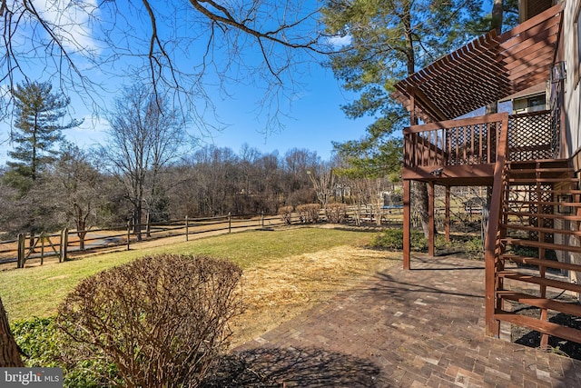 view of yard featuring a deck, fence, and stairway