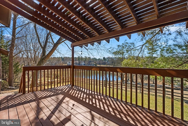 deck featuring a lawn and a pergola