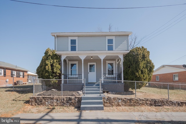 view of front facade with a porch and a fenced front yard