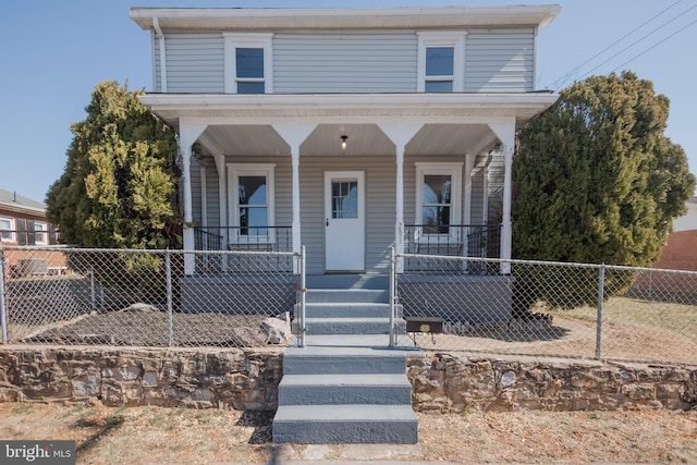 view of front of home featuring covered porch and fence