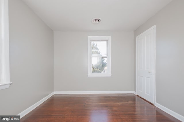 interior space with wood finished floors, visible vents, and baseboards