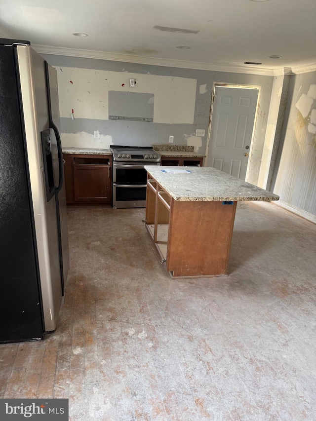 4818 Deanwood Dr, Capitol Heights, MD 20743 - kitchen with a center island, ornamental molding, light stone counters, appliances with stainless steel finishes, and brick floor