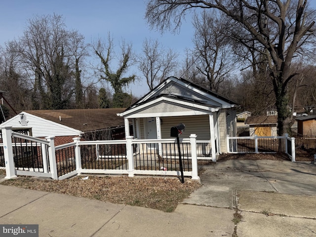 4818 Deanwood Dr, Capitol Heights, MD 20743 - view of front of house featuring a fenced front yard, a porch, and concrete driveway