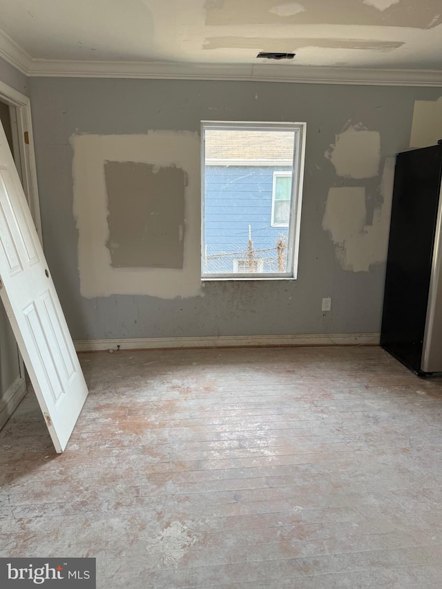 4818 Deanwood Dr, Capitol Heights, MD 20743 - unfurnished bedroom featuring visible vents, baseboards, crown molding, and freestanding refrigerator
