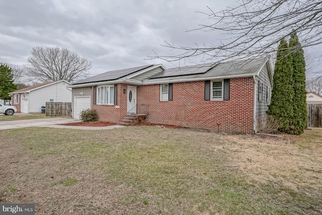 ranch-style home with concrete driveway, brick siding, a front lawn, and fence