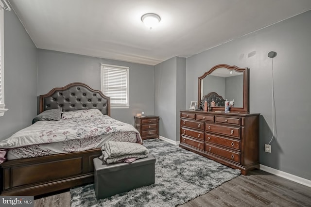 bedroom featuring baseboards and wood finished floors