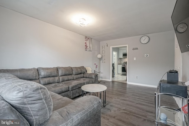 living room featuring dark wood finished floors and baseboards