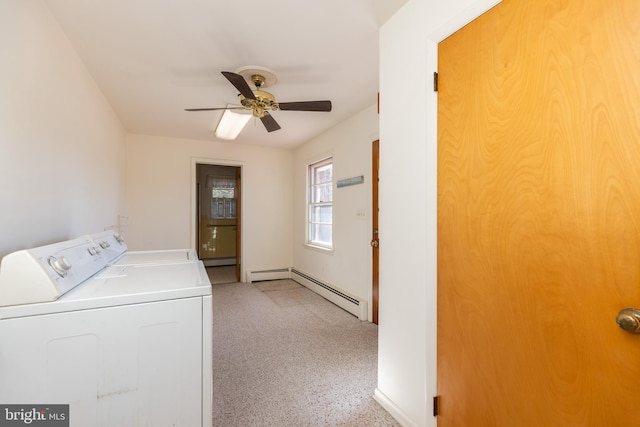 washroom with laundry area, baseboard heating, washing machine and clothes dryer, and a ceiling fan