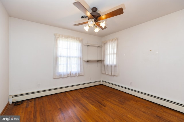 spare room featuring wood-type flooring, ceiling fan, and baseboard heating