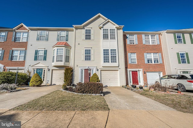 townhome / multi-family property with driveway and an attached garage