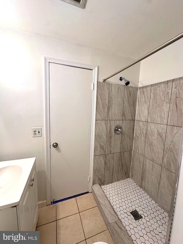 full bath featuring a shower stall, vanity, and tile patterned floors